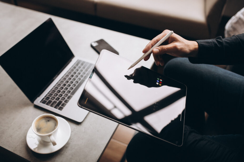 man working on tablet close up at the table